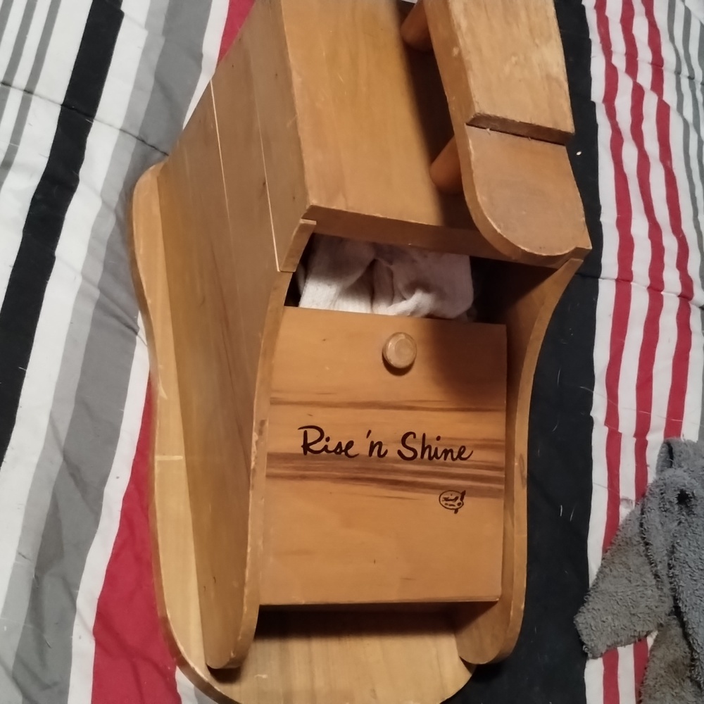 An old shoe shine wood box shaped like a shoe